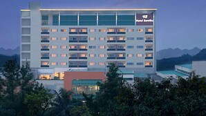 A multi-story hotel with a prominent sign reading "Hotel Santika." - Hotel Santika Bogor (Bogor)