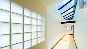 A modern interior with a long hallway, large windows, and a skylight. - Krabi Apartment Hotel (Krabi)