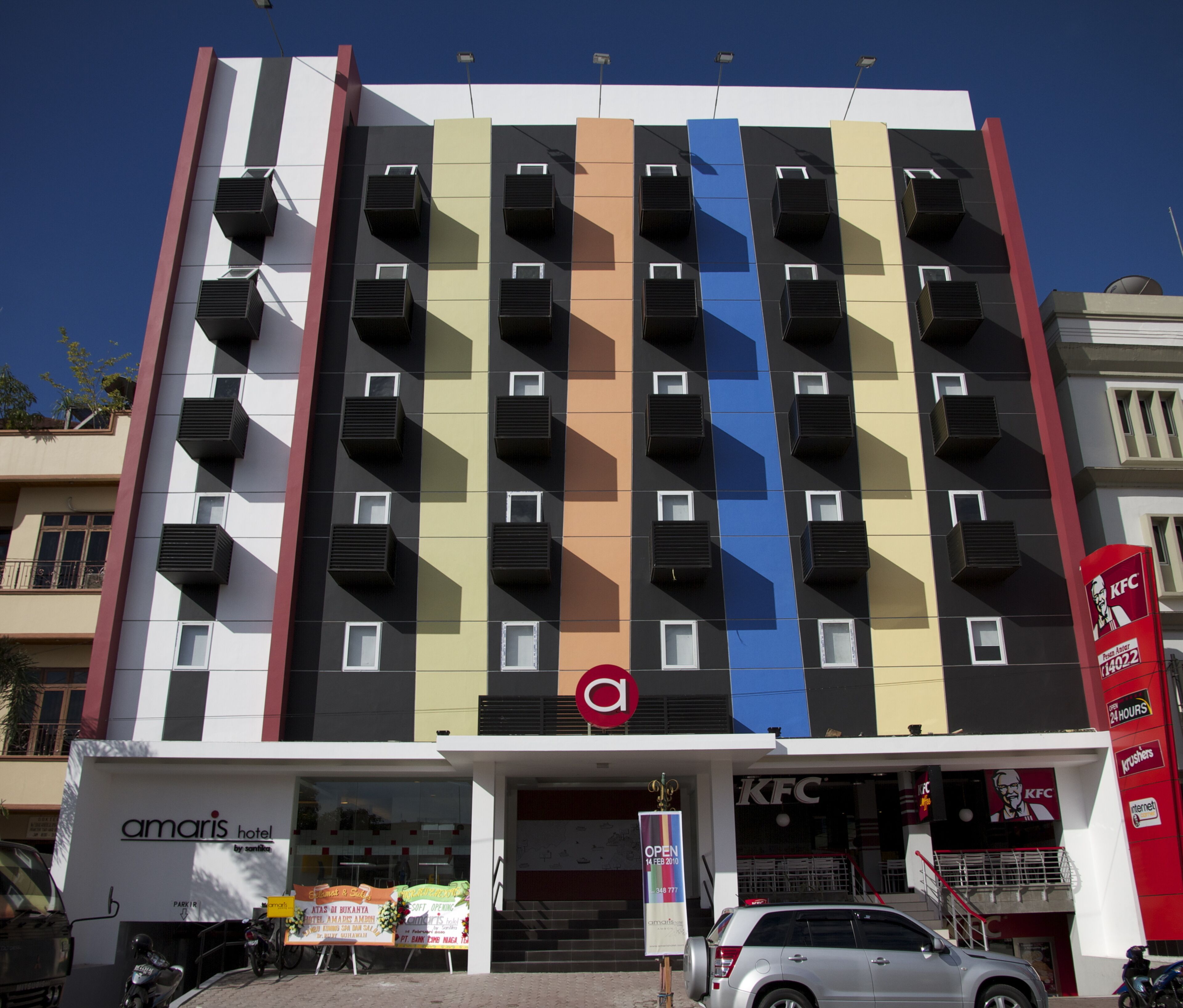 A multi-story hotel with a modern facade, featuring a prominent KFC restaurant on the ground floor.
