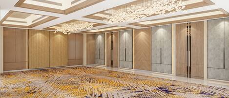 A spacious room with a patterned carpet, wooden panel walls, and a modern chandelier.