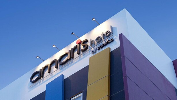 A hotel sign with the name 'amaris hotel' and 'santorini' below it.