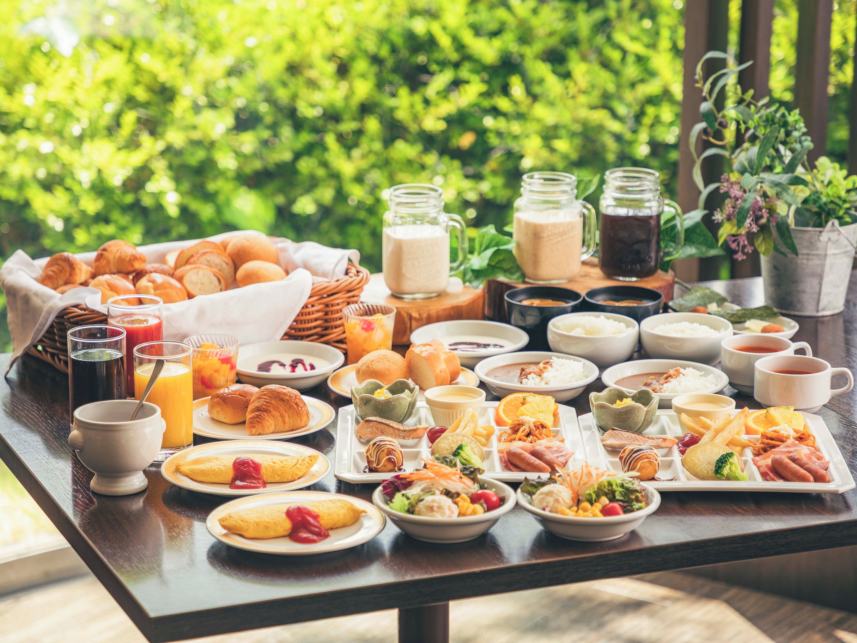 A breakfast buffet with various dishes and beverages.