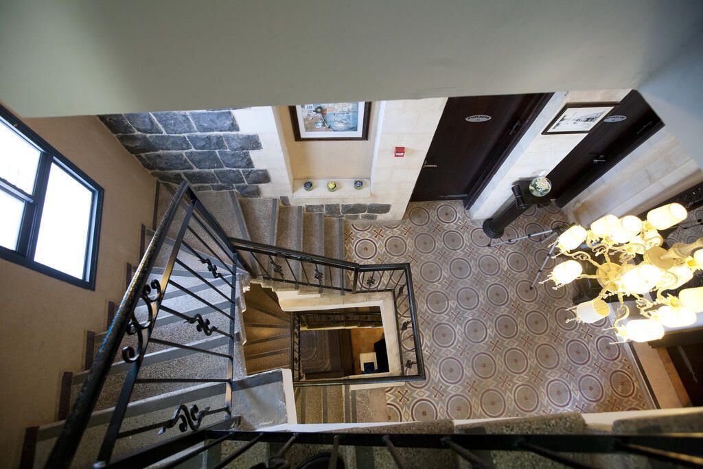 A staircase with a metal railing leading to a landing.