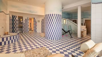 Experience the unique checkered design throughout the lobby, featuring a central column, seating areas, and a staircase with a distinctive railing.