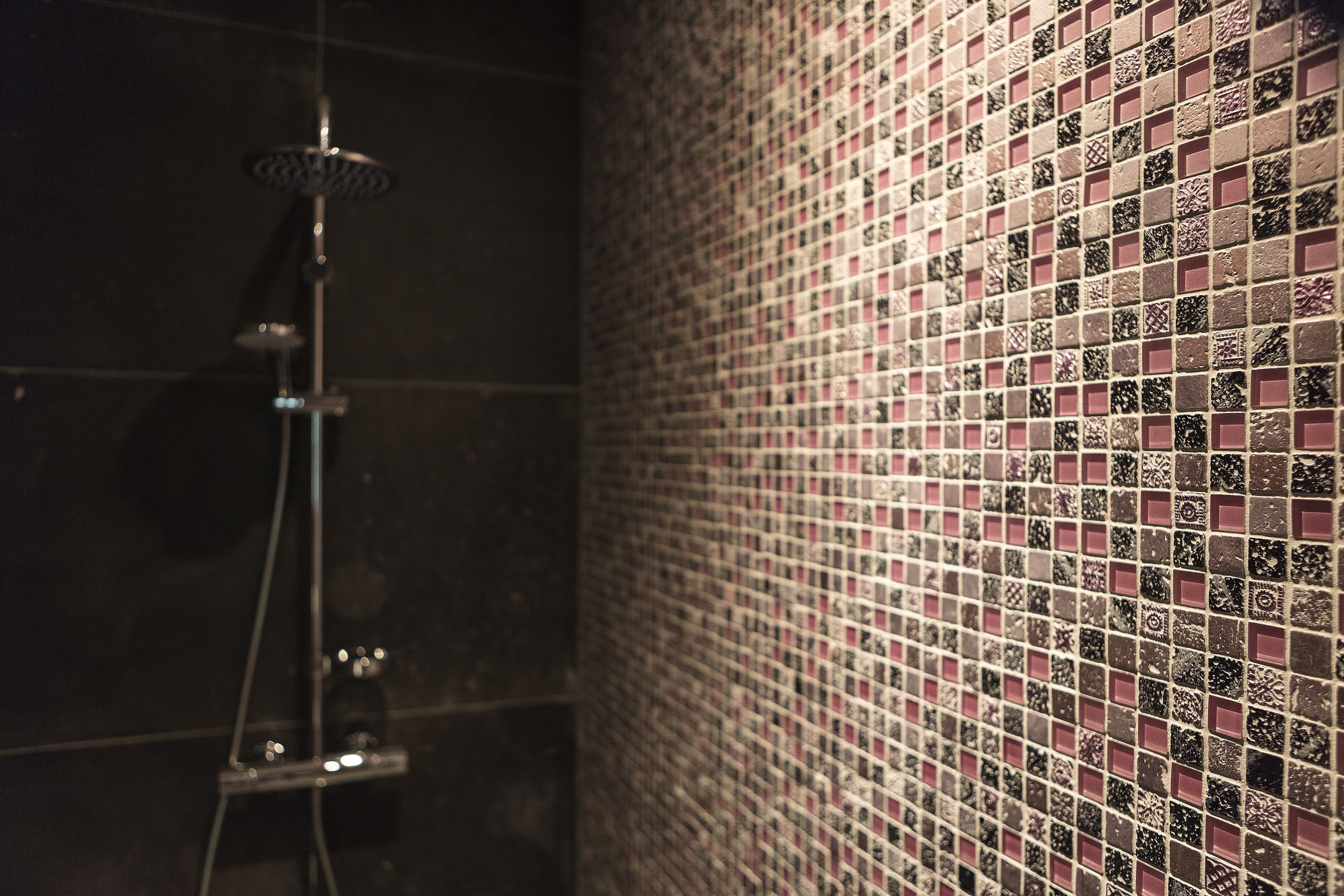 A tiled shower area with a showerhead.