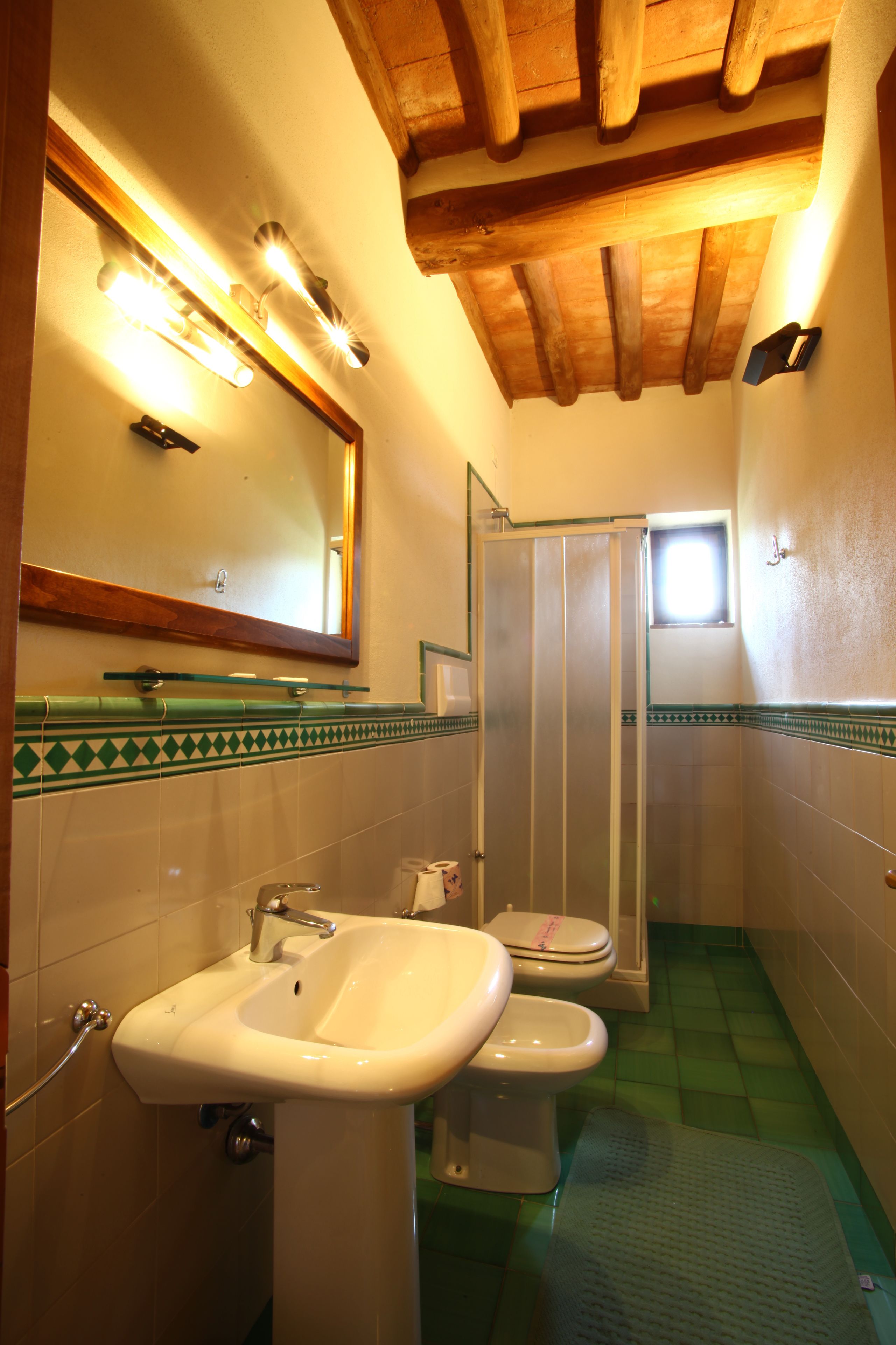 A bathroom with a sink, toilet, and shower.