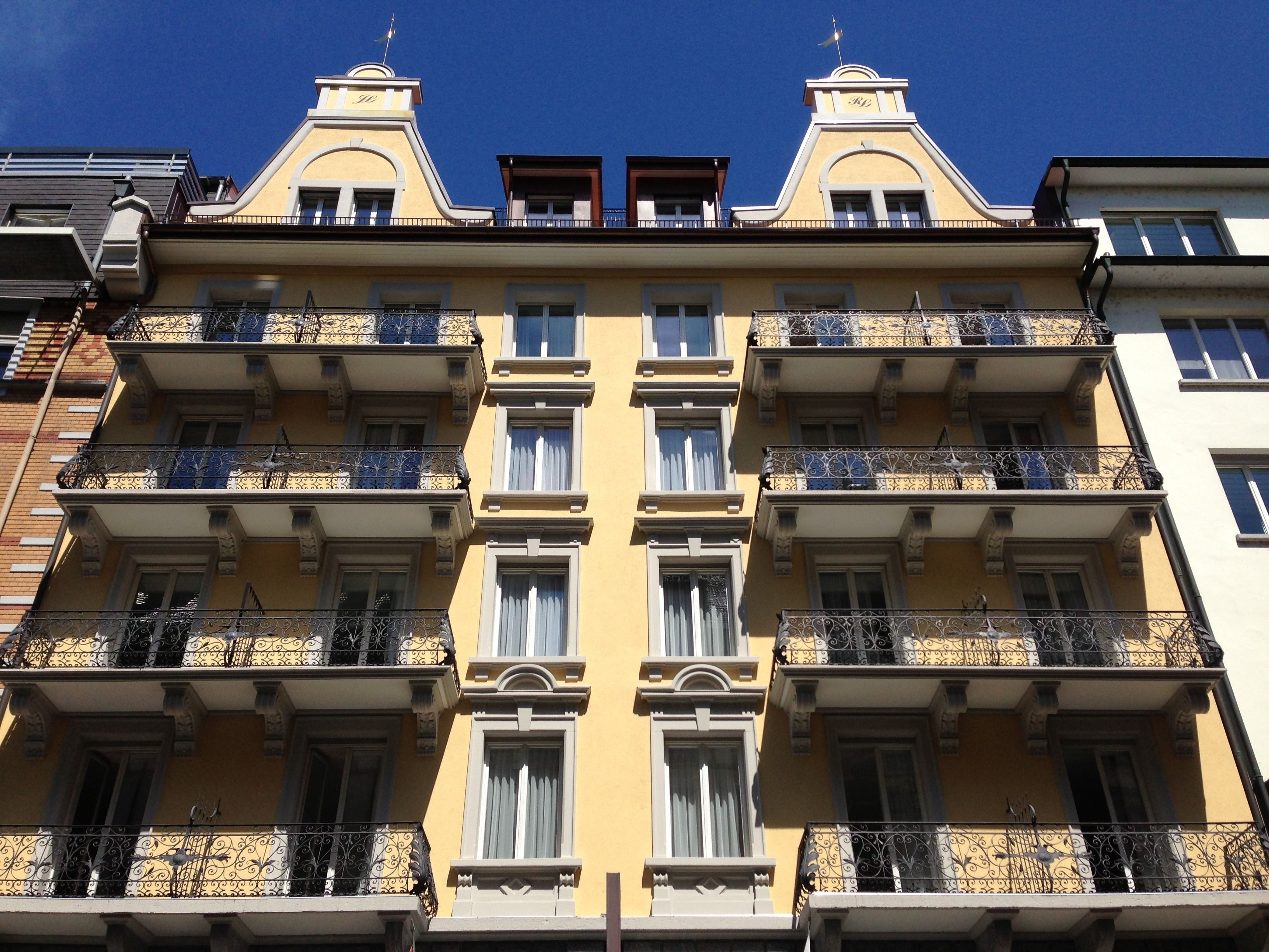 A multi-story building with ornate balconies and a symmetrical facade.