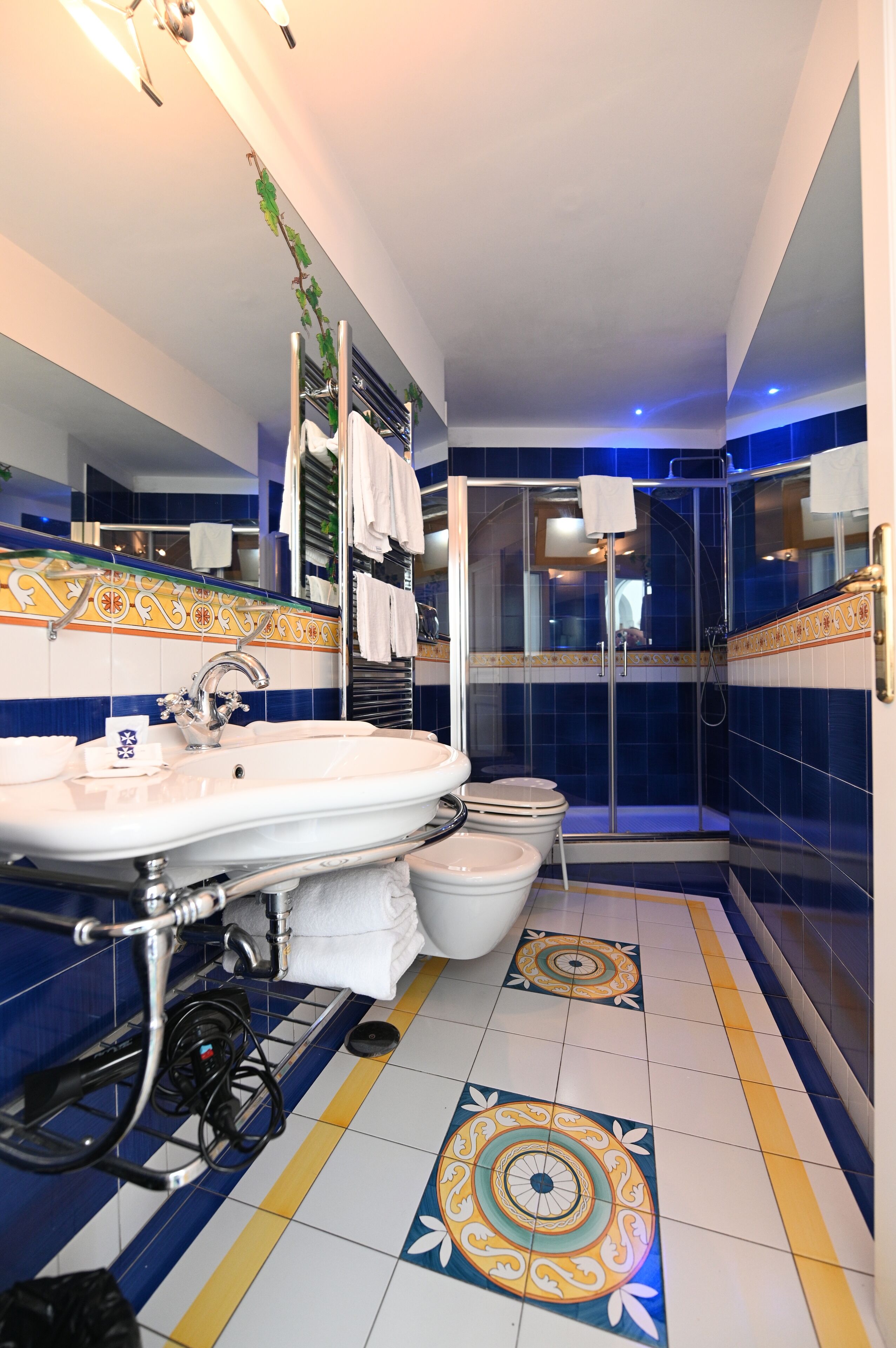 A bathroom with a sink, toilet, and shower area.
