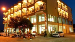 A multi-story hotel with balconies, large windows, and a sign indicating it is a hotel. - Çesme Sirin Villa Otel (Cesme)