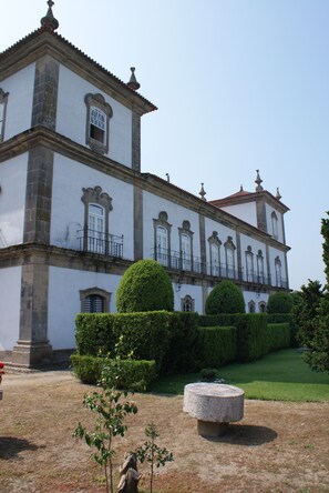 A historic building with a symmetrical facade, multiple windows, and a central balcony.
