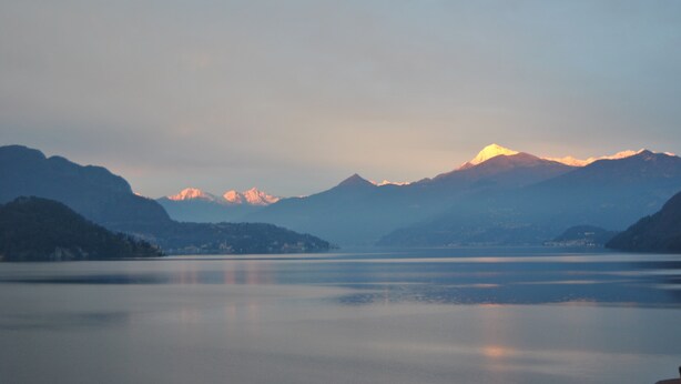 A serene lake with mountains in the background.