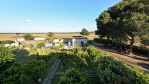 A resort with a pool area, a small building, and a well-maintained garden. - Masseria Li Campi (Cavallino)