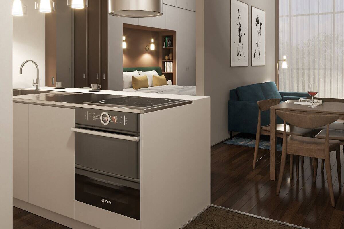 A modern kitchen with a central island, built-in oven, and stainless steel appliances.