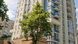 A high-rise residential building with multiple balconies and a staircase leading to the entrance. - Lukyanovsky (Kyiv)