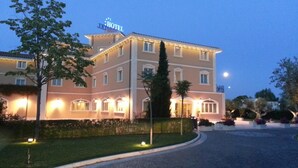 A multi-story hotel with a well-lit entrance and a sign indicating it is a hotel. - Villa Michelangelo (Citta Sant'Angelo)