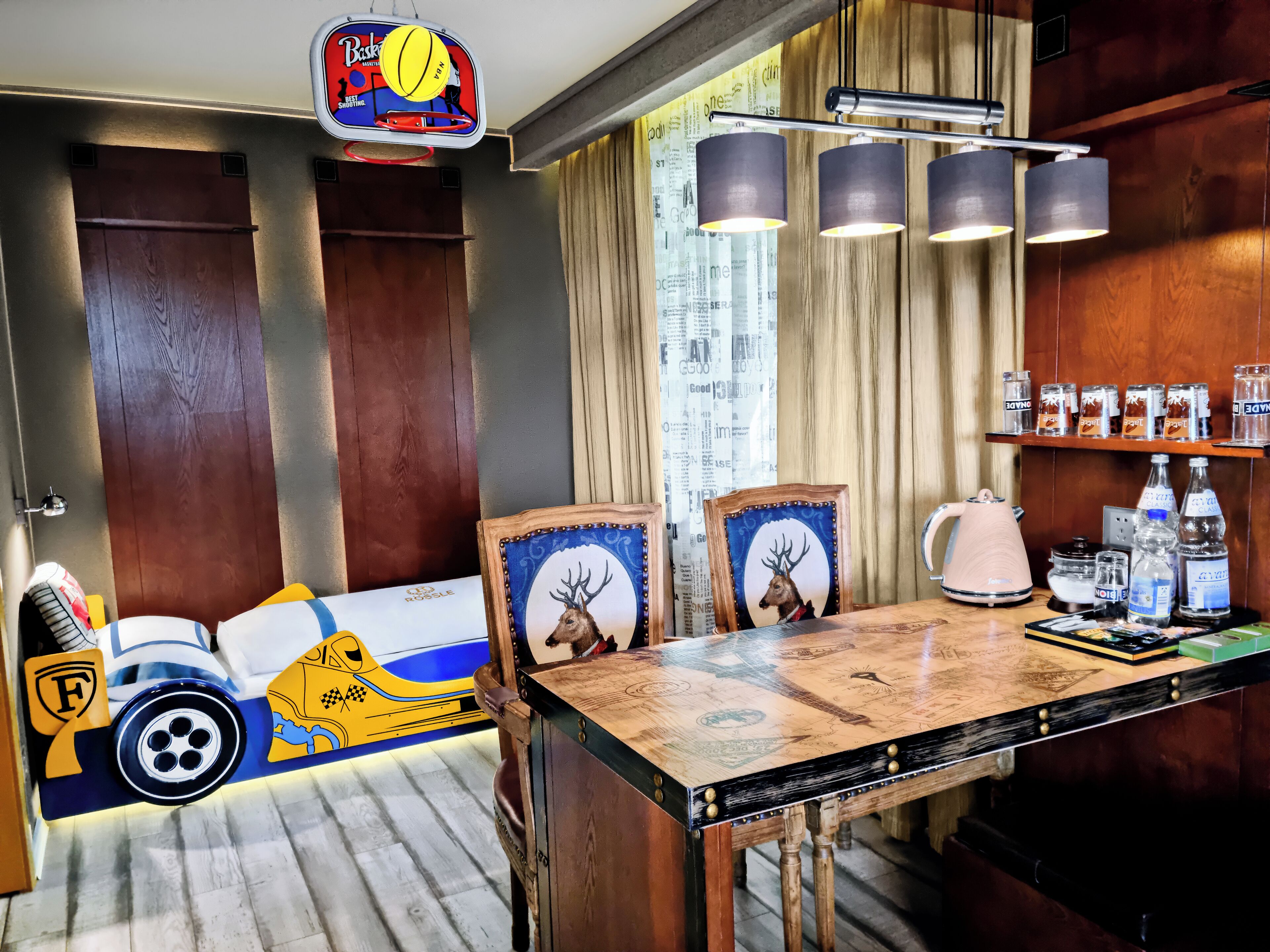 Un comedor con una mesa de madera, sillas y una decoración de pared con temática deportiva.