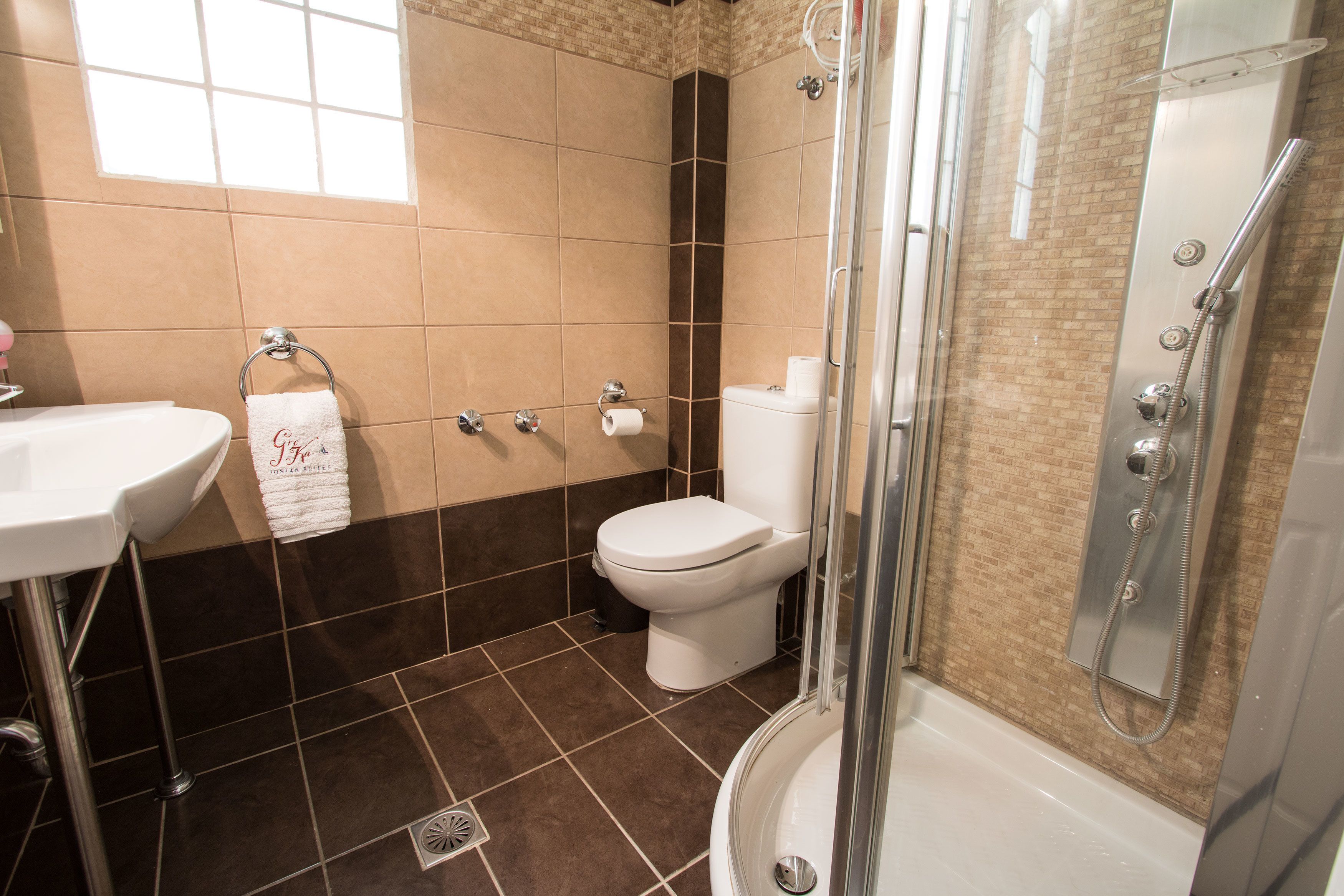 A bathroom with a sink, toilet, and shower.