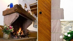 A fireplace with a stone mantle and a wooden door. - Auberge Etchoinia (Lasse)