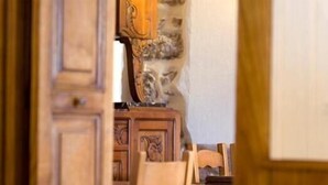 A wooden interior with a stone wall and a wooden cabinet. - Auberge Etchoinia (Lasse)