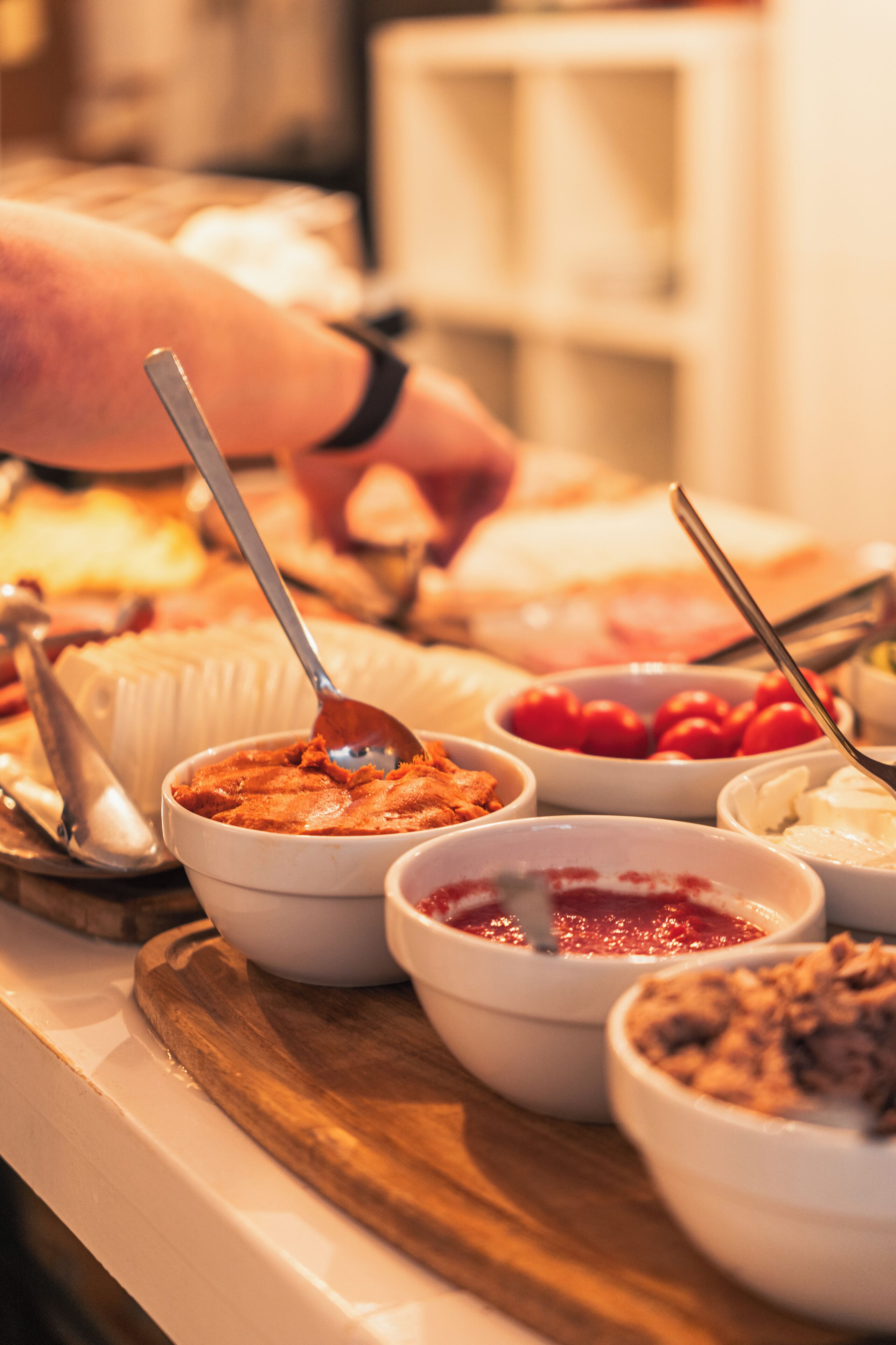 A buffet with various dishes and utensils.
