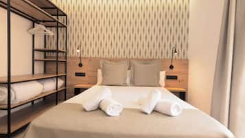 A neatly made bed with pillows and rolled towels, a wooden shelf unit with folded towels, and a wall with a striped pattern.