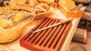 A buffet setup with various food items and serving utensils. - Hotel La Milagrosa (Alicante)