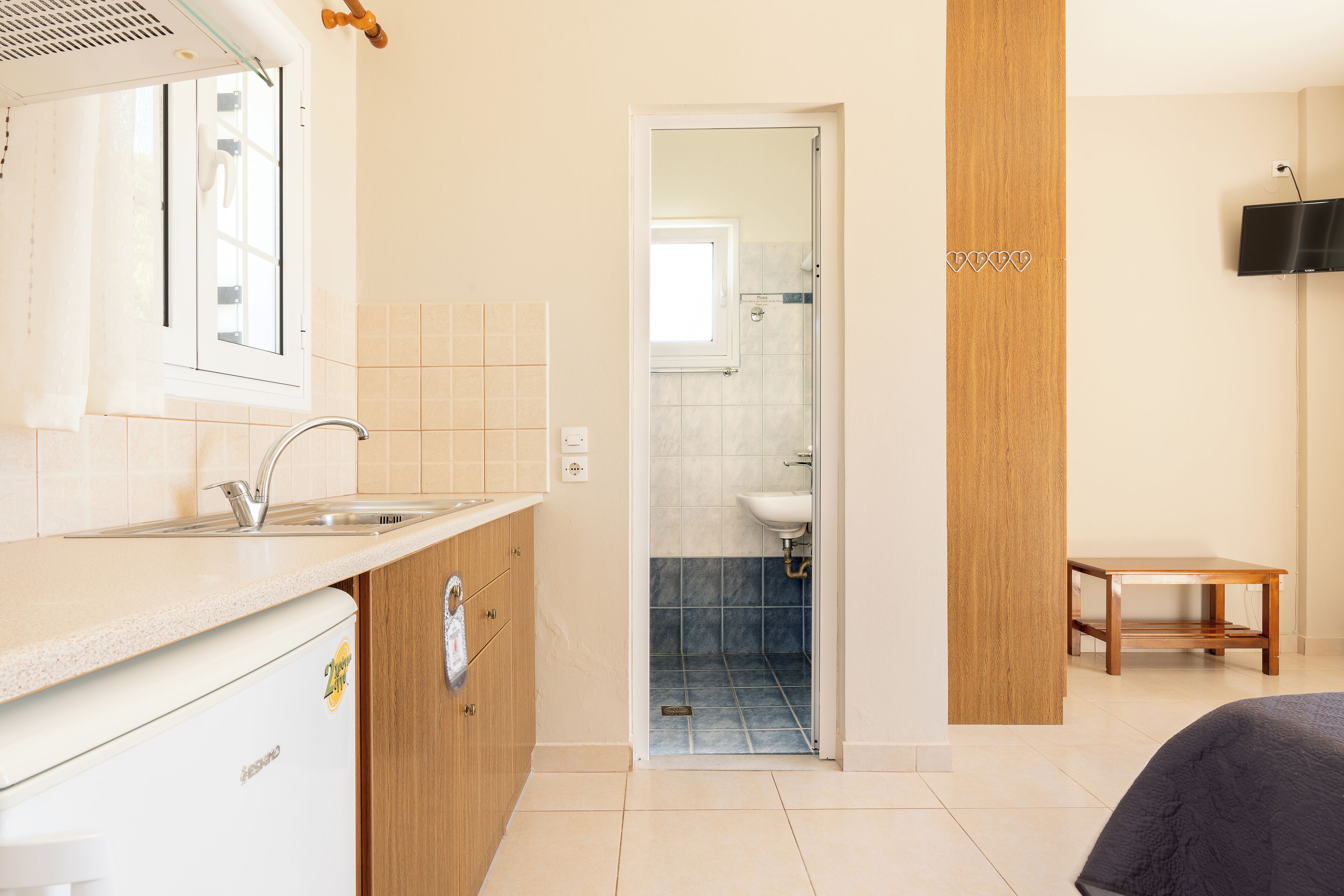 A modern bathroom with a shower, sink, and toilet.
