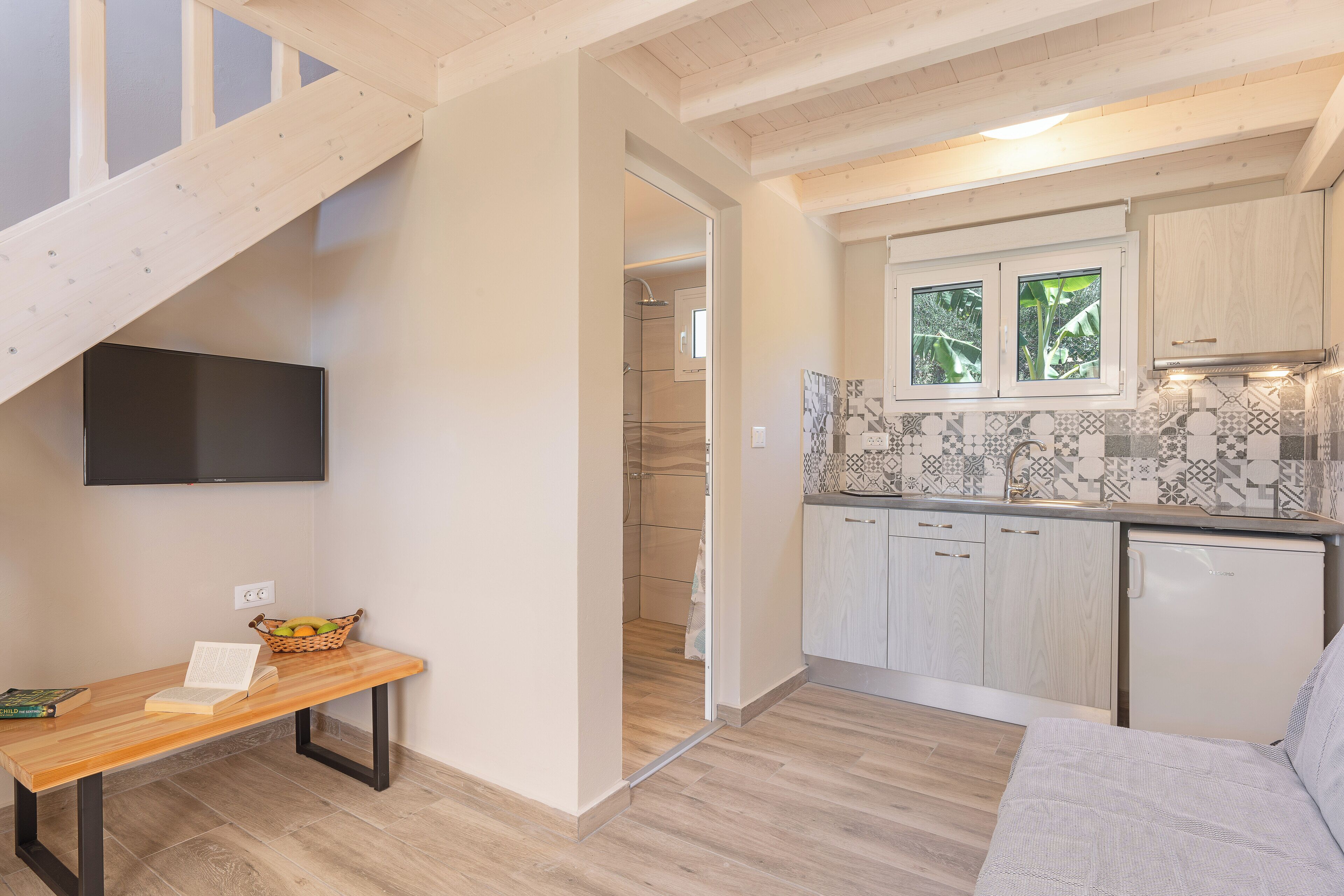 A modern kitchen with wooden cabinets, a tiled backsplash, and a built-in oven.