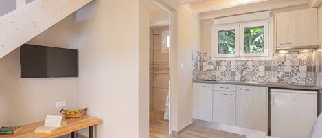 A modern kitchen with wooden cabinets, a tiled backsplash, and a built-in oven.