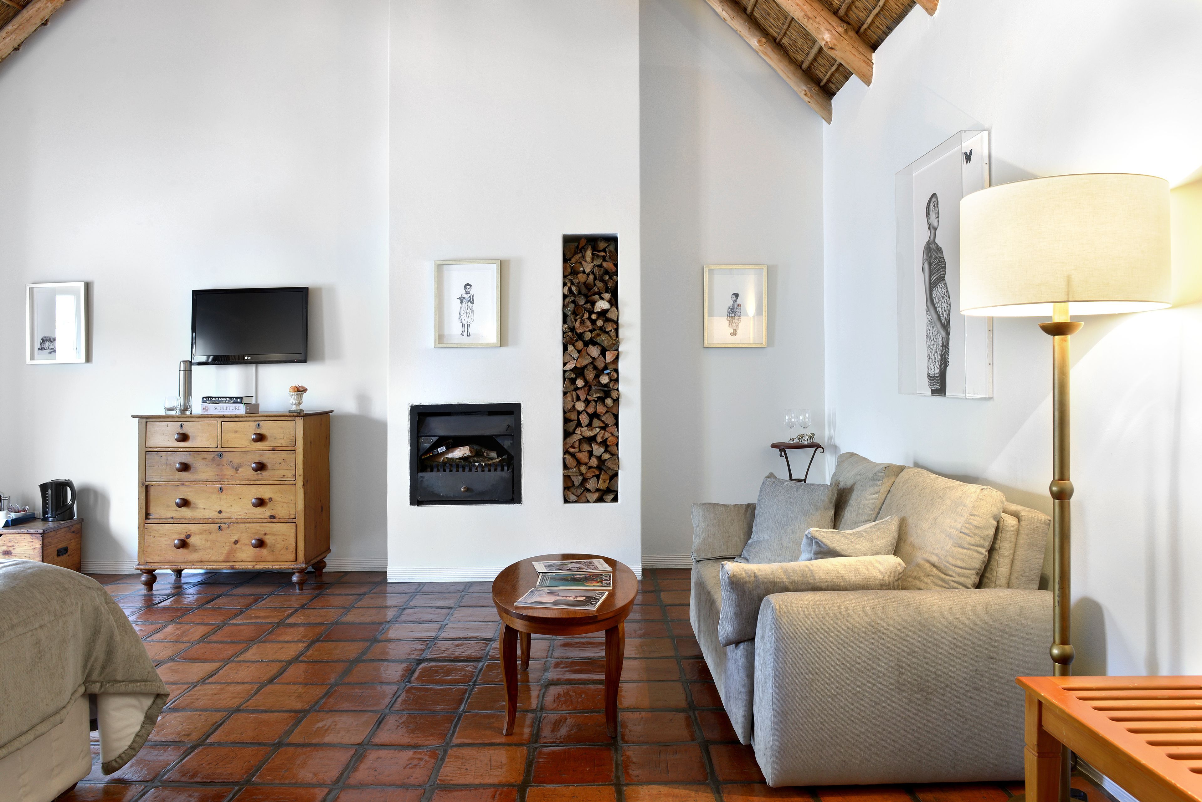 Una sala de estar con chimenea, televisor, sofá y una mesa de centro.