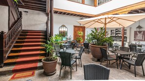 A multi-level indoor space with a staircase, seating area, and potted plants. - Isla Baja Suites (Garachico)
