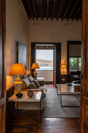 Deluxe Suite | Living area | Flat-screen TV, DVD player