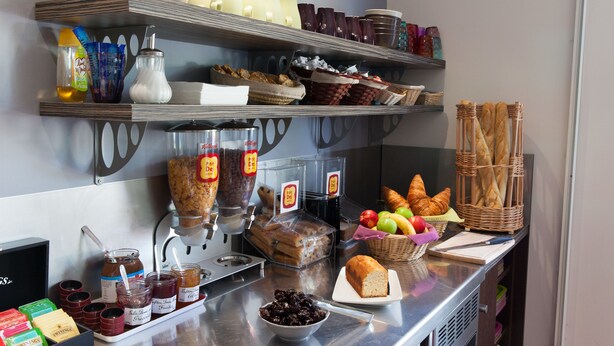 A buffet setup with various food items and condiments. - The Originals Access, Hôtel Bordeaux Lac (Bruges)