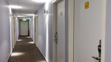 A hallway with doors, each marked with a number.