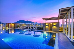A modern hotel pool area with a clear view of the mountains in the background, a covered seating area, and a well-lit pool. - ASHLEE Heights Hotel Patong (Patong)