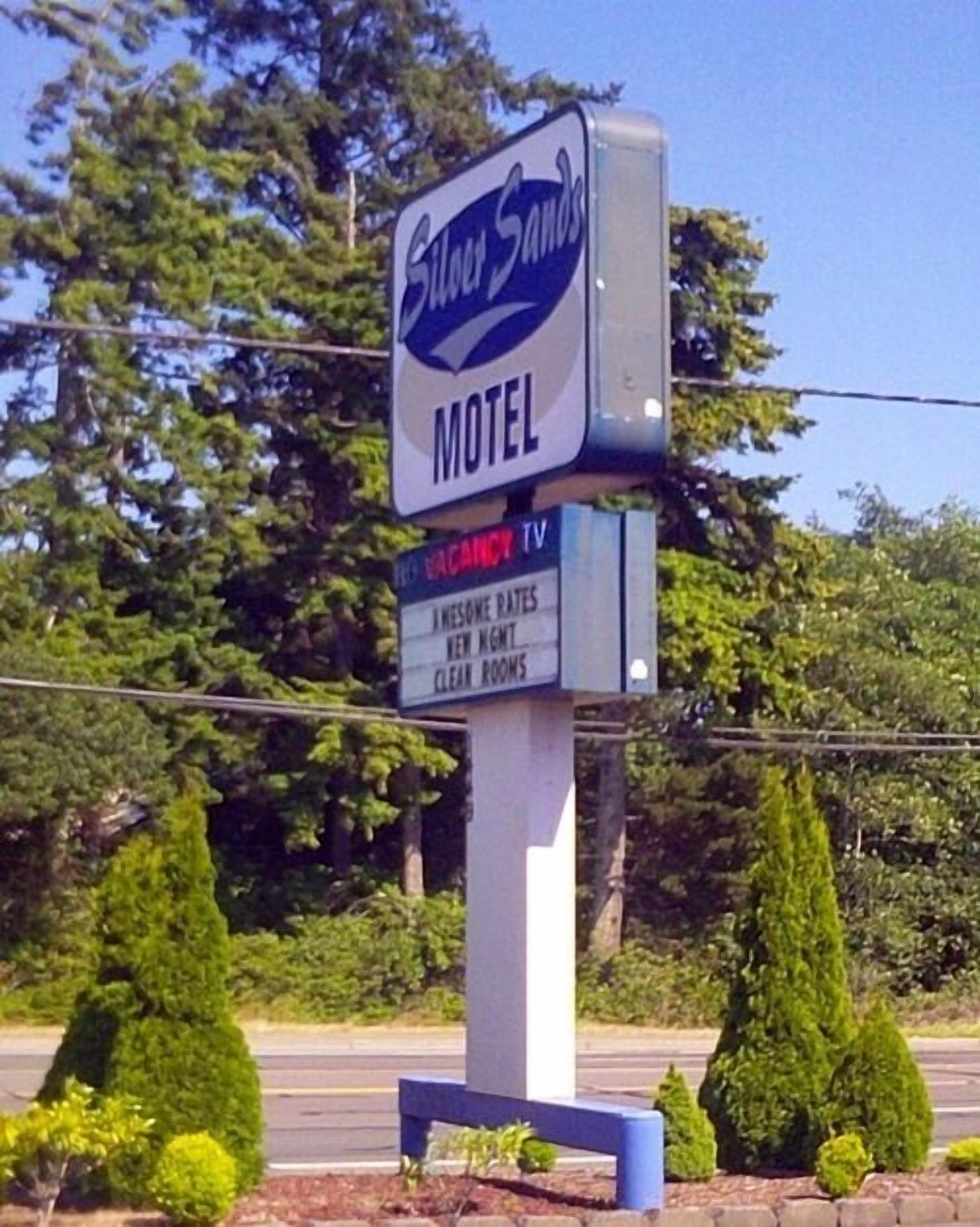 A motel sign with a TV rental service advertisement.