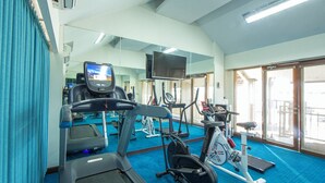 A gym with treadmills, stationary bikes, and exercise equipment. - Kuta Beach Hotel (Kuta)
