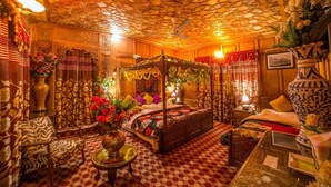 A traditional room with a four-poster bed, ornate ceiling, and floral decorations. - Swan Group Of Houseboats (Srinagar)