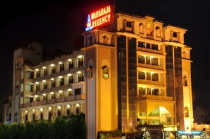 A multi-story hotel with a prominent sign reading "MAHARAJA REGENCY".