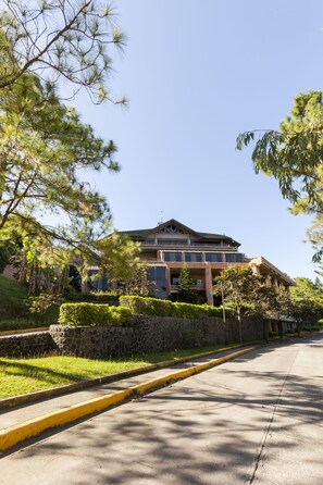 A large, multi-story building with a prominent balcony on the second floor. - Canyon Woods Resort Club (Laurel)