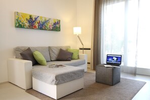 Apartment, Balcony | Living area | 32-inch flat-screen TV with digital channels, TV