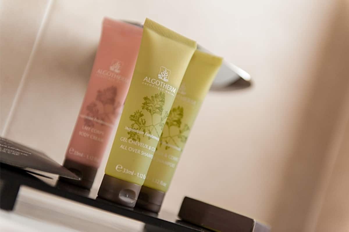 Three skincare products on a shelf.