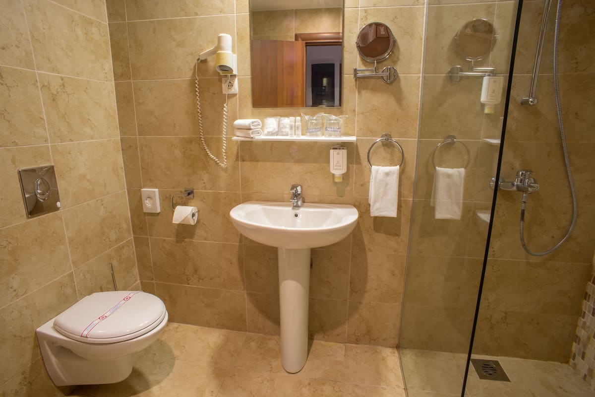 studio suite | bathroom | shower, free toiletries, hair dryer, bathrobes