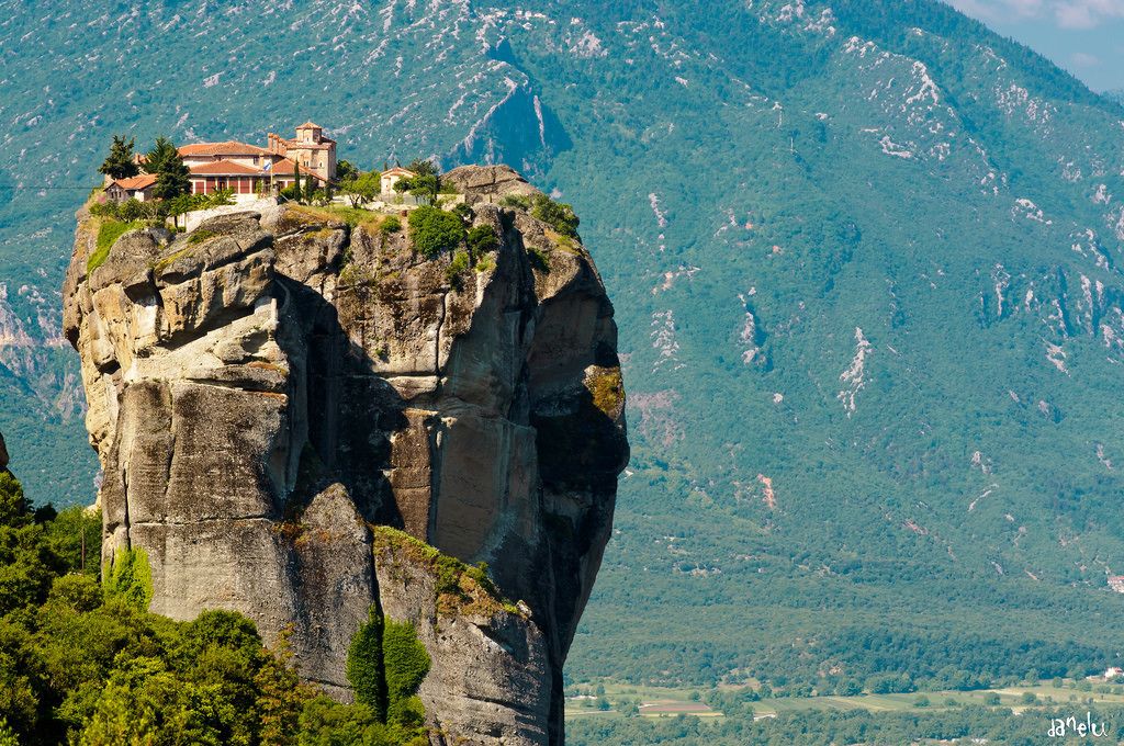 Un hôtel situé sur une falaise, offrant une vue sur les montagnes environnantes.