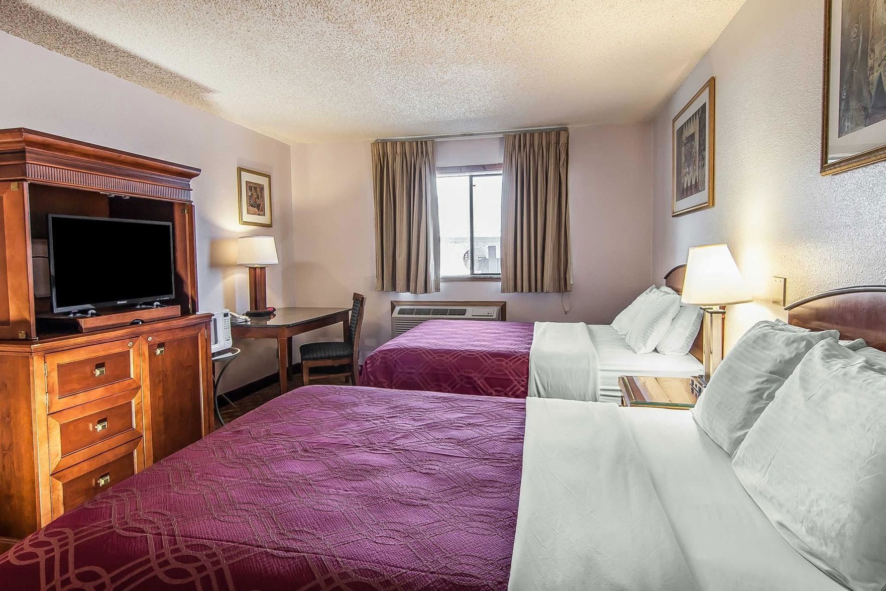 Hypo-allergenic bedding, desk, laptop workspace, blackout curtains