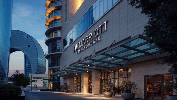 JW Marriott Absheron Baku hotel with a modern facade, large glass windows, and a well-lit entrance. - JW Marriott Absheron Baku (Baku)