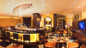A bar area with a checkered floor, a bar counter, and seating. - Vivanta Coimbatore (Coimbatore)