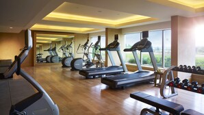 A modern gym with treadmills, elliptical machines, and free weights. - Vivanta Coimbatore (Coimbatore)