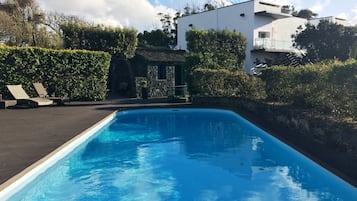 Utomhuspool, parasoller och solstolar