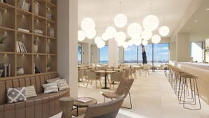 A modern interior with a seating area, bookshelves, and a dining space with round tables and chairs. - Hotel Las Arenas (Palma de Mallorca)
